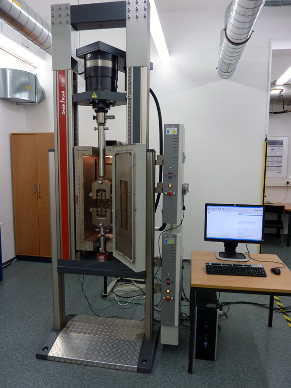Material testing machine for testing bonds with structural adhesives