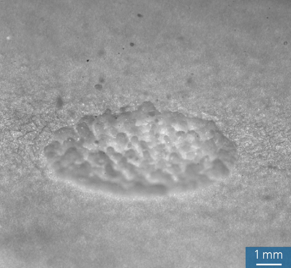 A high-speed image of the irradiation of a paper substrate with CO laser radiation reveals an intermediate liquid state.