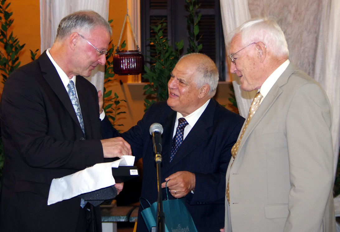 Prof. Carlo Misiano, chairman of the symposium (middle) and Prof. Angus Macleod (right) present the award to Prof. Andreas Leson (left) Prof. Carlo Misiano, chairman of the symposium (middle) and Prof. Angus Macleod (right) present the award to Prof. Andreas Leson (left)