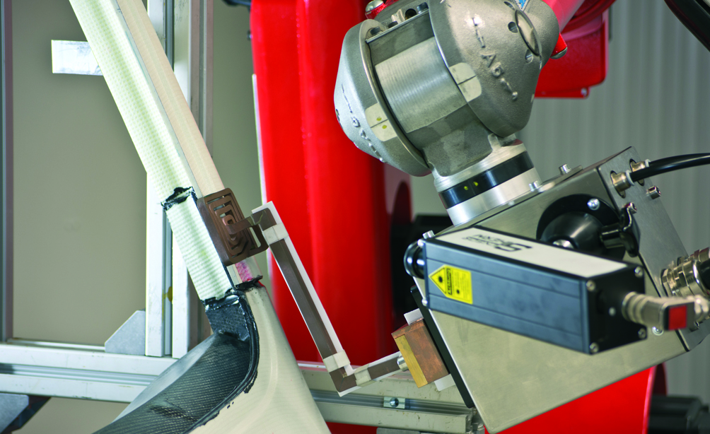 Pyrometer-controlled inductively accelerated adhesive hardening with industrial robot Pyrometer-controlled inductively accelerated adhesive hardening with industrial robot