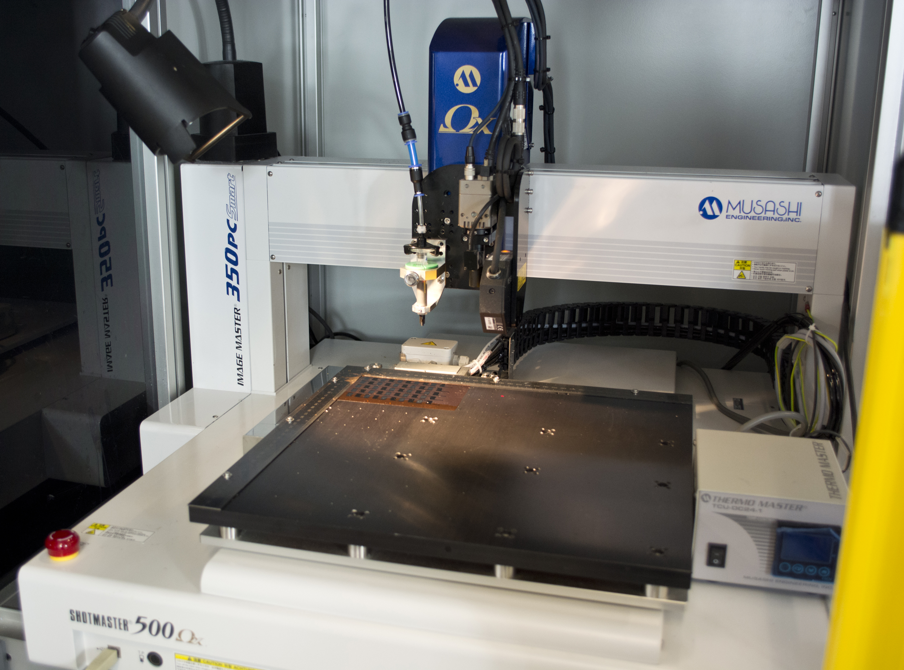 A dispensing printer coats films with the conductive and liquid polymer “Poly(Kx[Ni-itto])”.