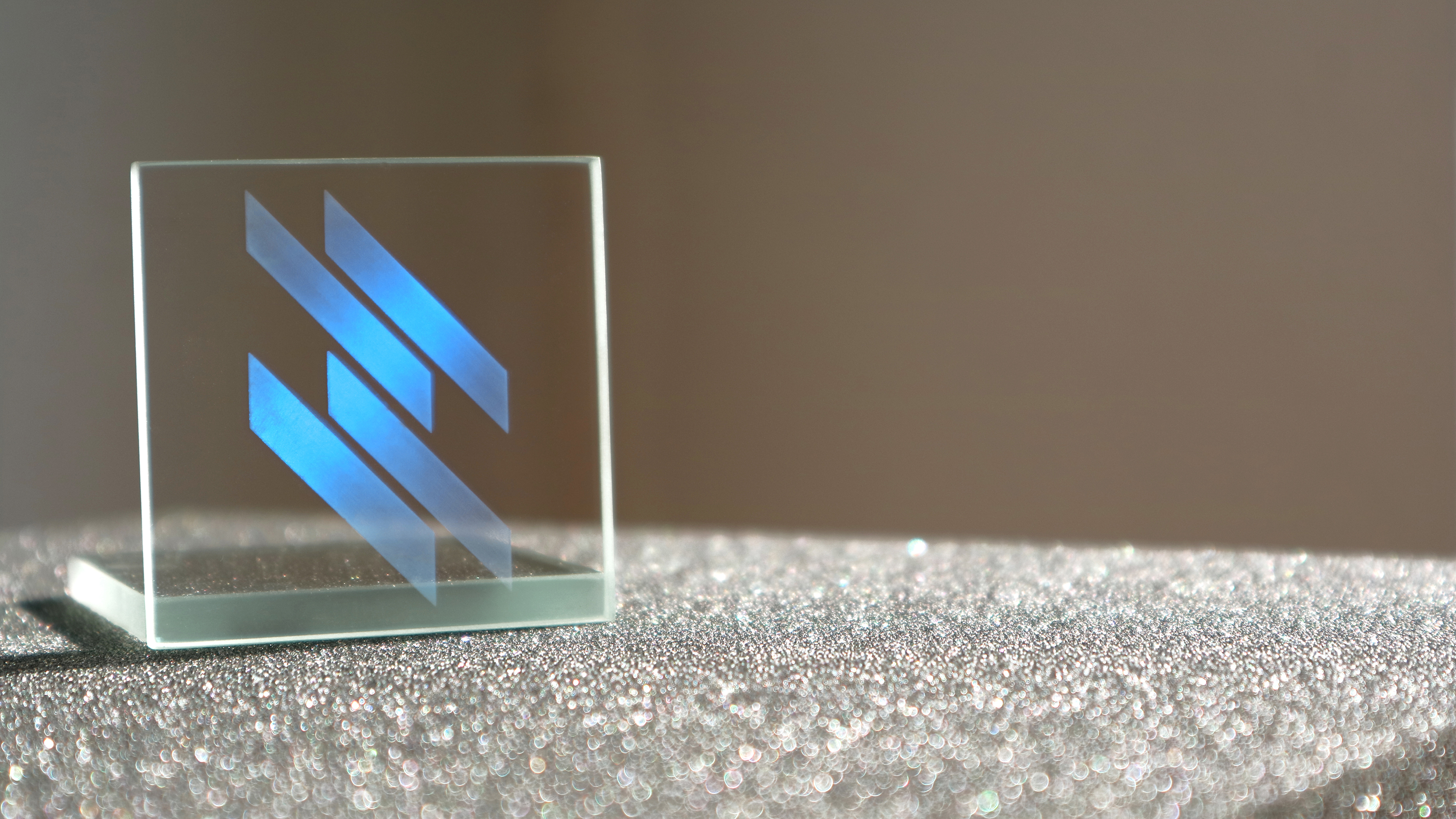 Laser-functionalized glass with decorative Fusion Bionic logo inspired by the morpho butterfly.